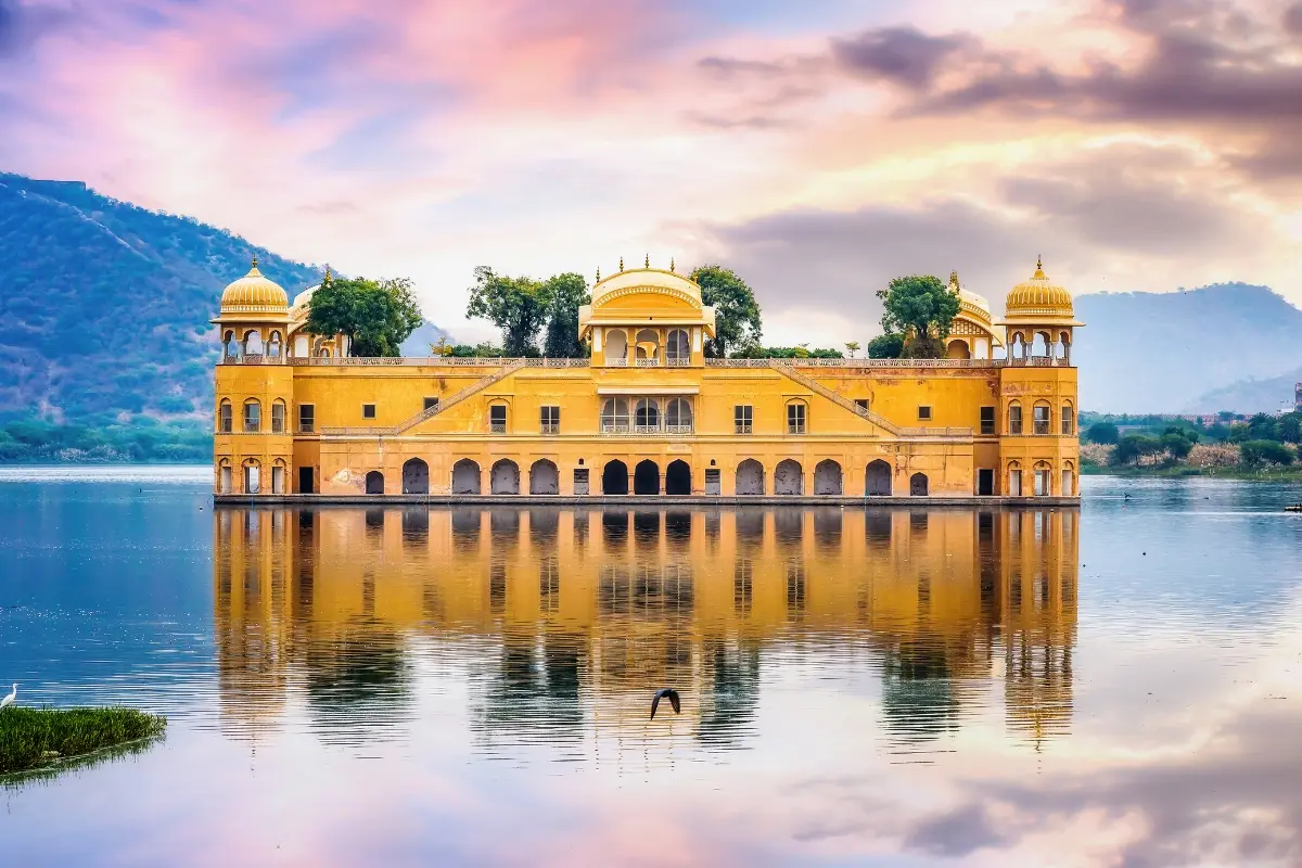 Jal Mahal Water Palace Jaipur floating on Man Sagar Lake at twilight with Aravalli Hills reflection — luxury tourism near Karbala showroom