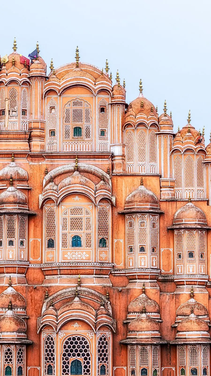 Hawa Mahal Palace of the Winds Jaipur pink sandstone honeycomb facade at sunrise — iconic luxury travel destination Rajasthan
